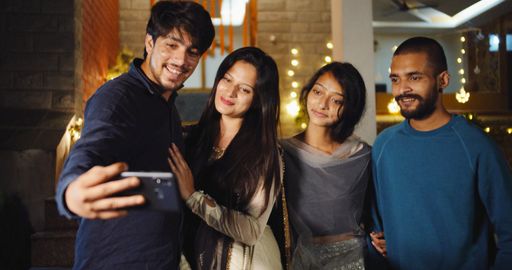 The South Asian young people from India taking selfies
