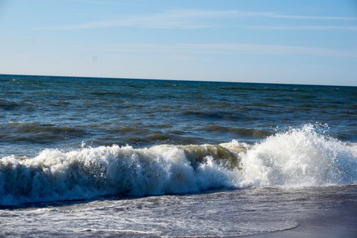 A beautiful view of the wavy sea under the blue sky on a sunny day
