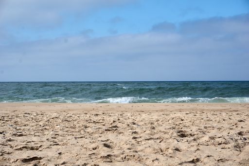 A beautiful view of a beach under the blue sky on a sunny day