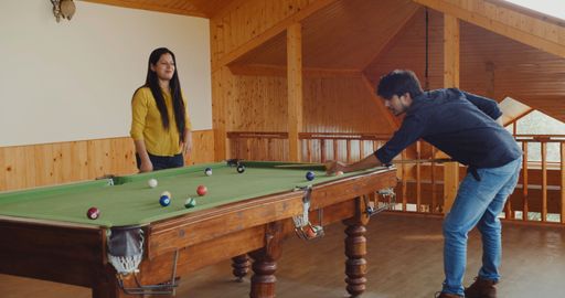 Young Indian people spending leisure time playing pool