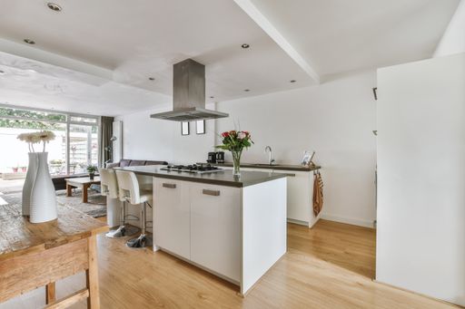 An interior shot of a modern kitchen in white tones and nice furniture