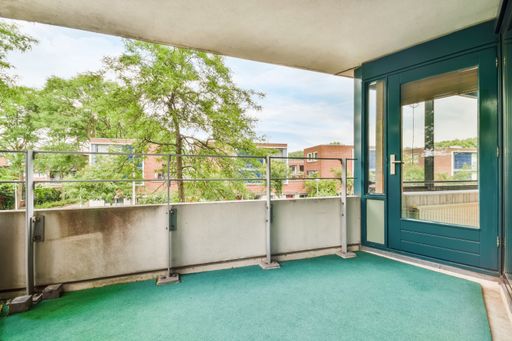 A beautiful shot of an empty balcony with a large green door