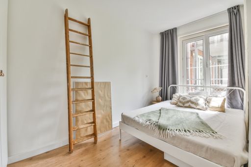 A beautiful furnished bedroom interior with windows