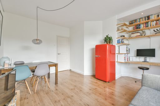A beautiful furnished living room interior with a red fridge