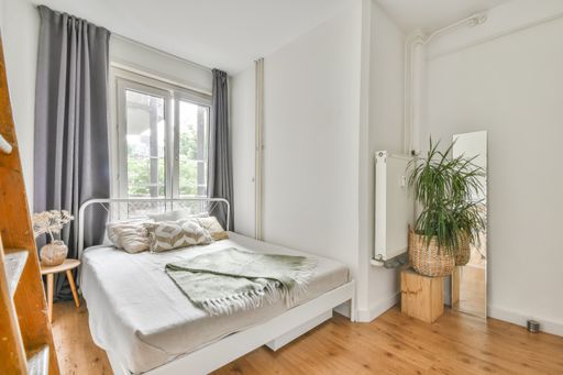 A beautiful furnished bedroom interior with windows