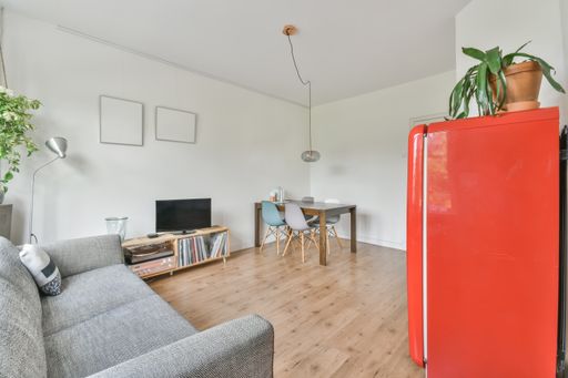 A beautiful furnished living room interior with a red fridge