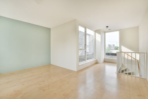 A beautiful renovated empty house interior with white walls and wooden floors