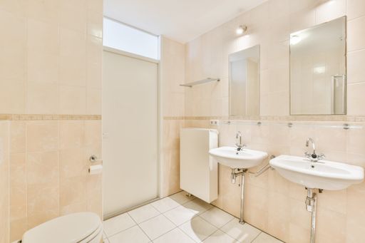 A beautiful renovated empty bathroom interior with two sinks