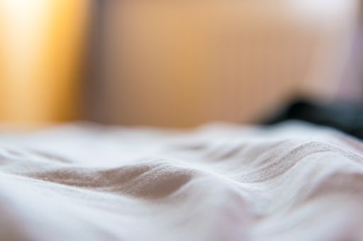 A selective focus shot of a part of a white cloth piece inside the room