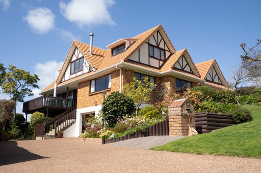 Low angle view of brick and tile suburban house.