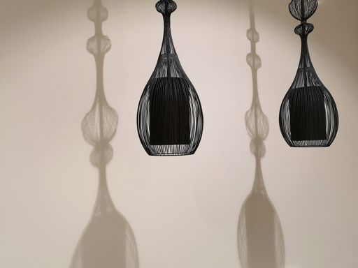 A closeup shot of the play of light and shadow with two beautiful black chandeliers