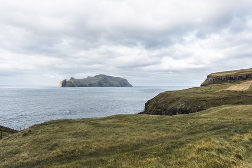 View from a hill on Mykines, Faroe Islands. Beautiful landscape with Atlantic ocean and island on the background