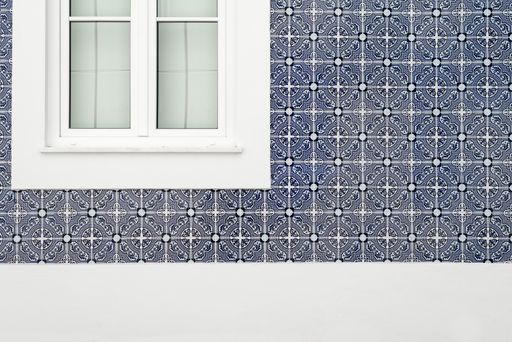 A traditional blue Portuguese tile pattern on a wall facade