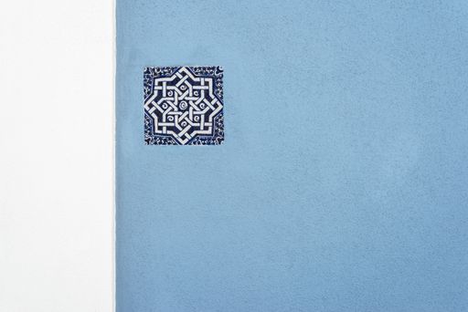 A blue wall with a traditional Portuguese tile design
