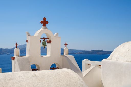 A beautiful shot of a bell tower on a sunny day in Santorini, Greece.