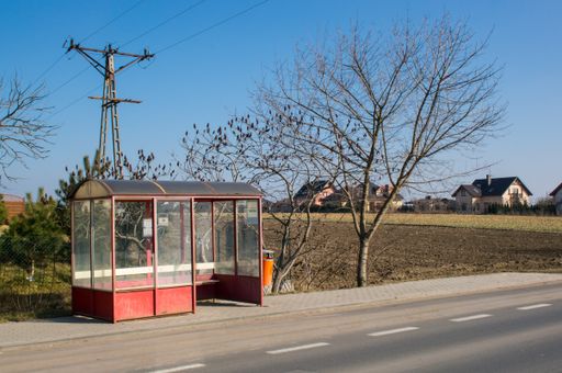 The Red bus stop with no people by the street