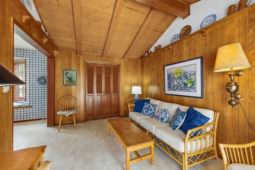 Mid-century style home featuring retro kitchen, wood-paneled living room, cozy bedrooms, and charming vintage bathrooms.