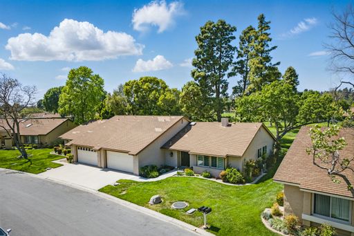 Comfortable California home with open-plan living, cozy bedrooms, golf course views, and lush backyard perfect for family living.