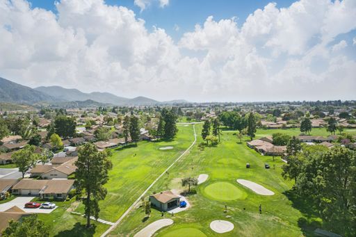 Comfortable California home with open-plan living, cozy bedrooms, golf course views, and lush backyard perfect for family living.