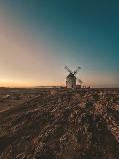 An old windmill against the sky during sunset