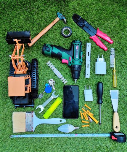 A top view of different tools on the green grass