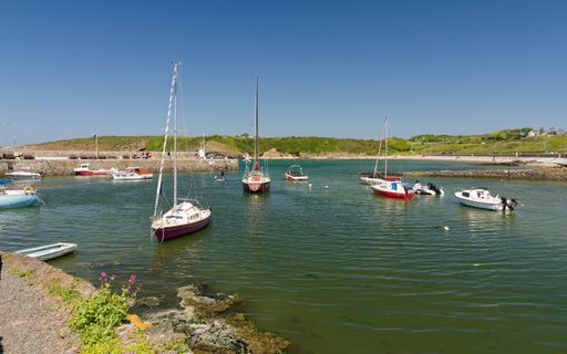 Cemaes Bay ,Anglesey, Wales, UK, 05-17-2025: Cemaes bay beach Anglesey. A group of sailboats are moored in the harbour.