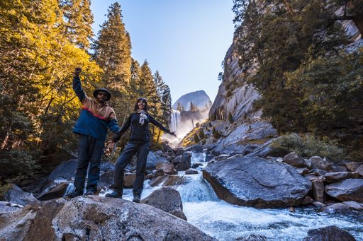 A couple hiking in the Vernal Falls waterfall of Yosemite National Park in the USA