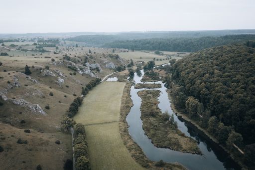 A fascinating aerial view of mountains and a river in daylight.