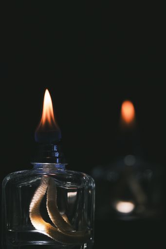 A vertical shot of the flames of scent diffusers in the dark