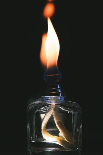 A vertical shot of the flames of a scent diffuser in the dark