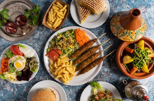 A top view of delicious Moroccan cuisine dishes on a marble table