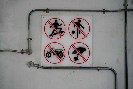Signs on the wall. No skating, games, bikes and littering allowed, Singapore city