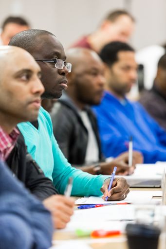 Diverse adult delegates on business lecture in a classroom