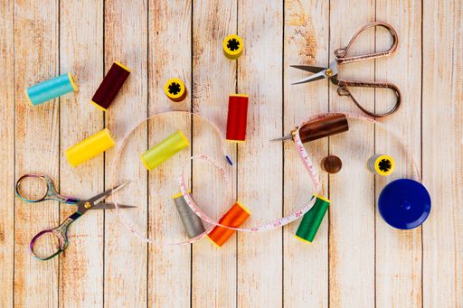 A top view of accessories for needlework on a wooden table