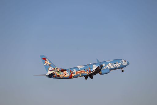 Alaska Airlines Boeing 737-800 in "Disneyland Pixar Pier" livery taking off from San Jose International Airport heading to Seattle