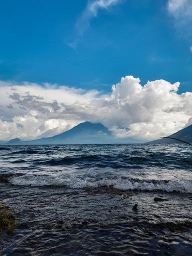 A serene landscape of Lake Atitlan on a cloudy day in Guatemala