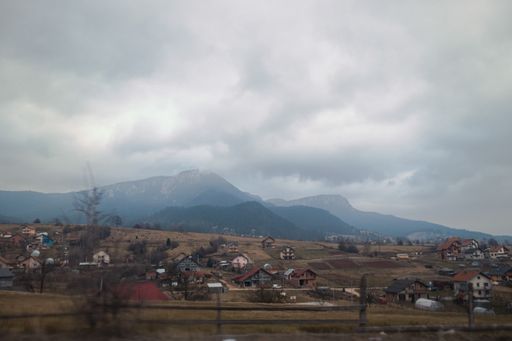 A small village in a mountainous area on a cloudy day