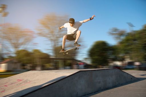 A young Argentinian male skateboarding  in the park