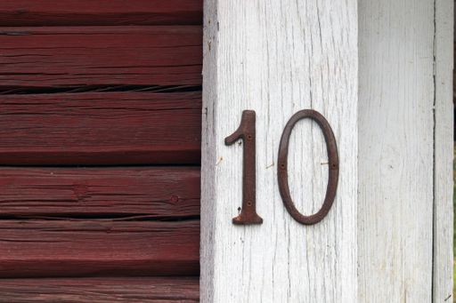 A closeup shot of the wall of an old house number 10