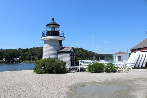 A beautiful view of Lighthouse in Mystic Seaport under a blue clear sky in Connecticut