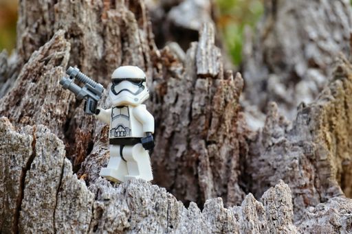 A close-up shot of a lego toy figure standing outdoors.