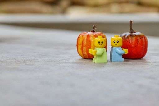 A close-up shot of lego toy figures standing outdoors.