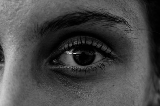 A grayscale closeup of a female brown eye