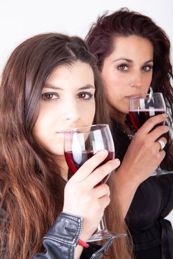 Two young beautiful brunette women and white background.