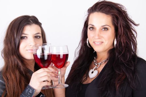 Two young beautiful brunette women and white background.