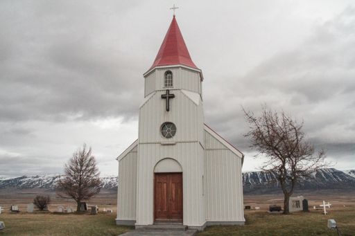 A beautiful shot of the white church with the blue sky in the background