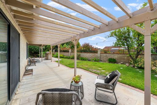 Single-level California home featuring a spacious kitchen, shaded patio, landscaped yard, and bright living spaces.