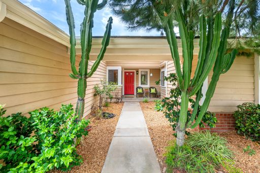 Single-level California home featuring a spacious kitchen, shaded patio, landscaped yard, and bright living spaces.
