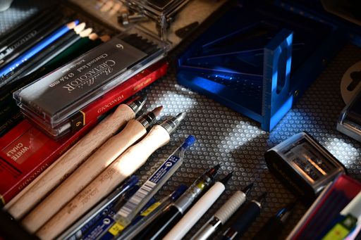 Neatly arranged pencils, brushes, and colorful tools nestled inside a well-used drawer.