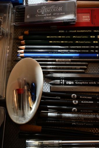 Organized pencils and brushes in a colorful drawer